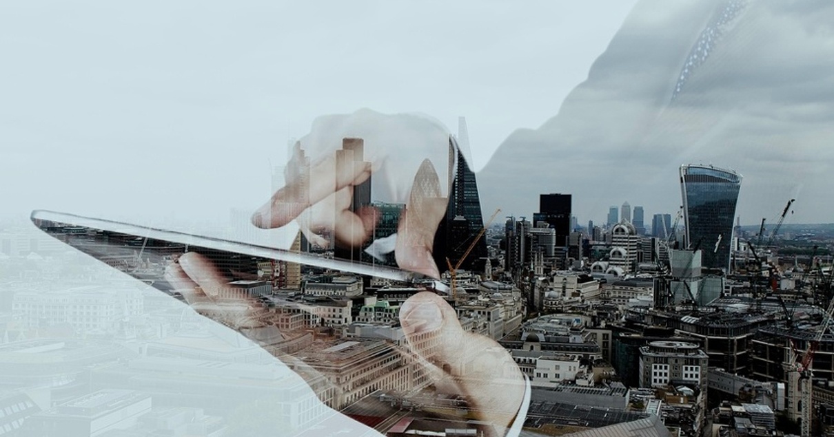 Double exposure of businessman working with new modern computer and london city background as concept